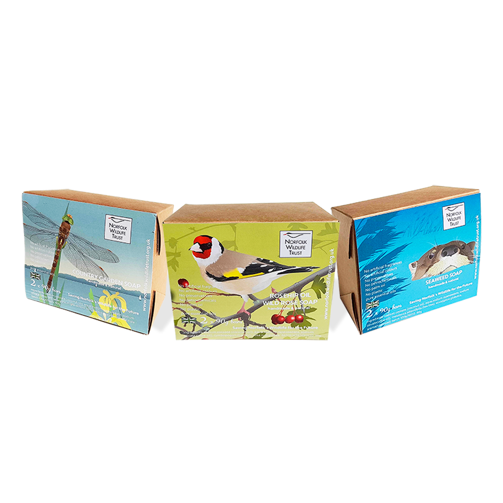 A brown Kraft gift box of two bars of soap decorated with an image of a goldfinch and the Norfolk Wildlife Trust logo