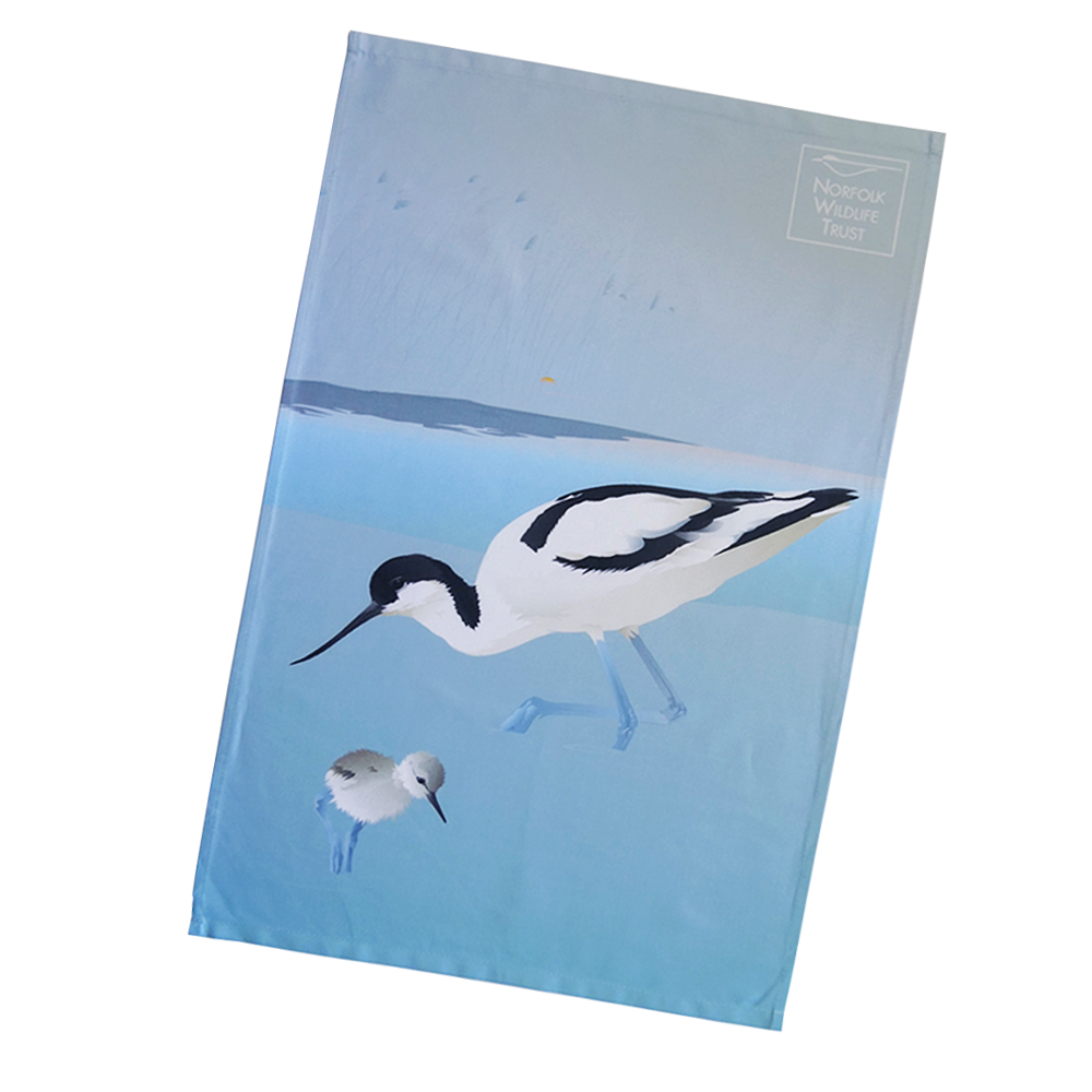 A blue rectangular tea towel features an avocet and chick