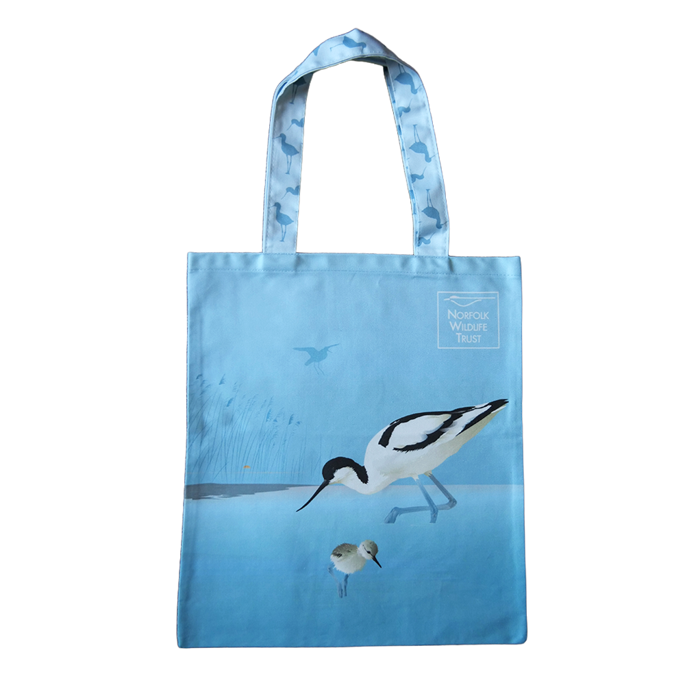 A blue rectangular tote bag features an avocet and chick