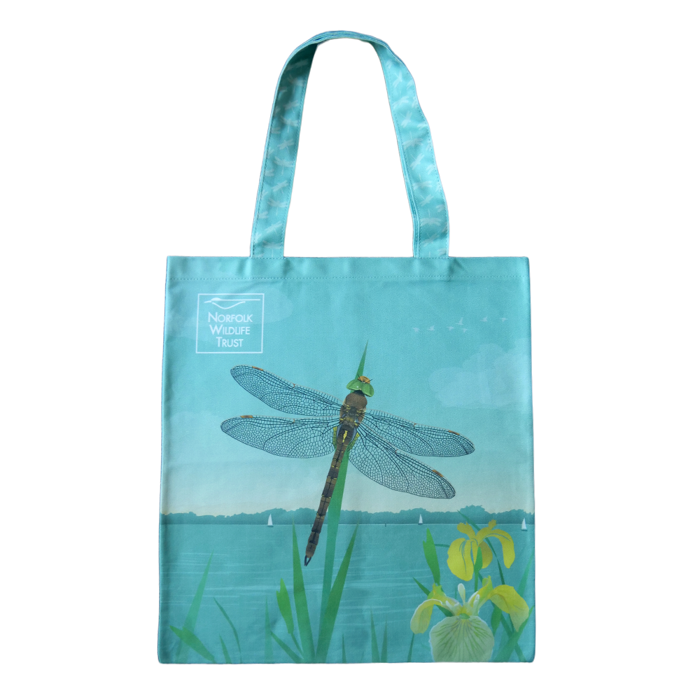 A blue rectangular tote bag features a Norfolk hawker dragonfly and yellow iris on the Norfolk Broads.