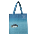 A blue rectangular tote bag features an otter peeking out from a reed-lined river or broad